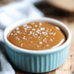 Instant Pot Dulce de Leche in a jar with spoon